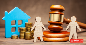 Two wooden figures stood next to a gavel, a model house, and a stack of coins. SB Lawyers' divorce solicitors will represent you Two wooden figures stood next to a gavel, a model house, and a stack of coins. SB Lawyers' divorce solicitors will represent you